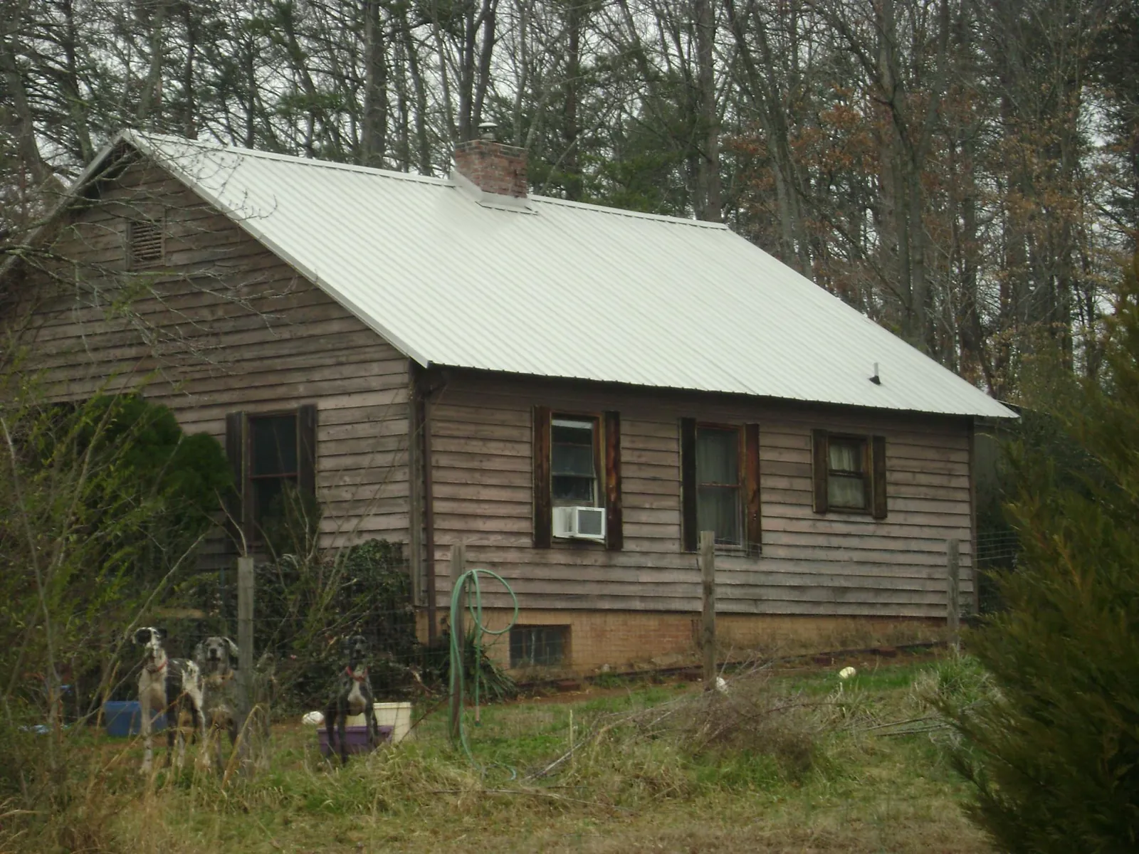 White metal roof on an old wood sided farmhouse, from a Metal Roof Installation job in Lowden